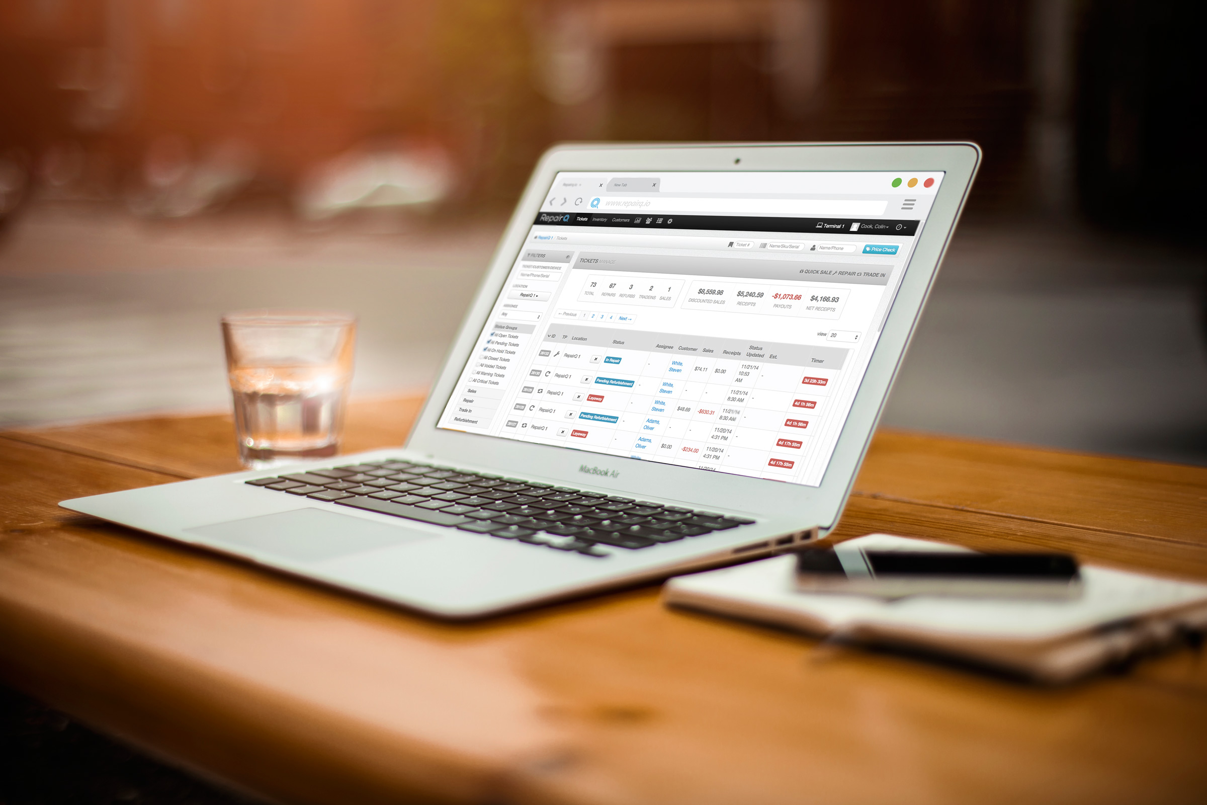 Laptop displaying RepairQ business management dashboard