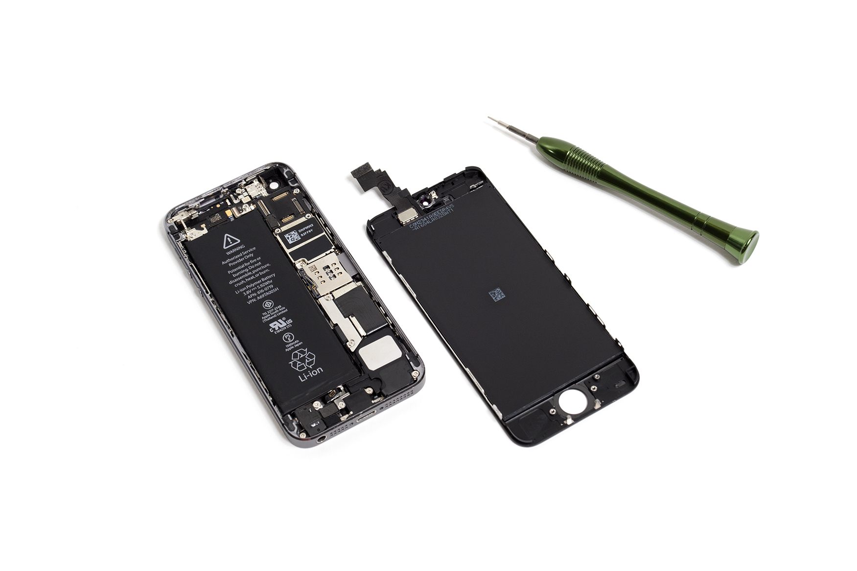 Phone broken apart, lying on a plain white background next to some phone repairing tools