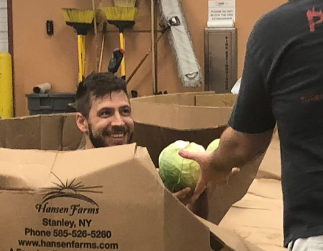 Jared Warren, ServiceCentral's digital marketing manager, having fun volunteering at the Community Food Bank of Eastern Oklahoma