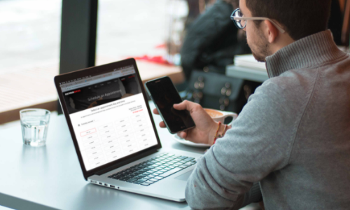 Schedule an Appointment customer easily navigating through a Qsite-powered repair shop website while looking at his phone