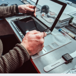 Technician repairing tablet Male hands repairing an iPad