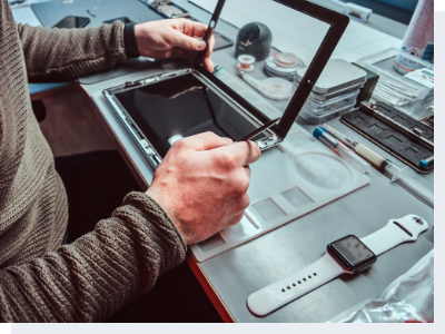 Technician repairing tablet Male hands repairing an iPad