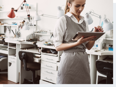 A woman standing in an office and working on an iPad