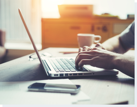 Safeware protection products include major electronics Person on laptop browsing protection plan options from Safeware.